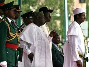 Nigeria's former president Olusegun Obasanjo, centre, stands next to Nigeria's new president Umaru Yar'Adua, 56, right, after he was sworn in, in Abuja, Nigeria, Tuesday, May 29, 2007. A reclusive former governor hand-picked by departing President Olusegun Obasanjo was sworn in as Nigeria's new leader Tuesday in the first transfer of power from one elected government to another in Africa's most populous country. (AP Photo/George Osodi)